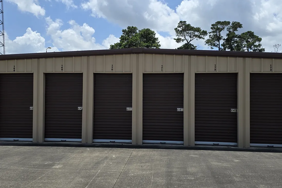 Row of clean drive-up self storage units with roll-up doors in Orange, TX