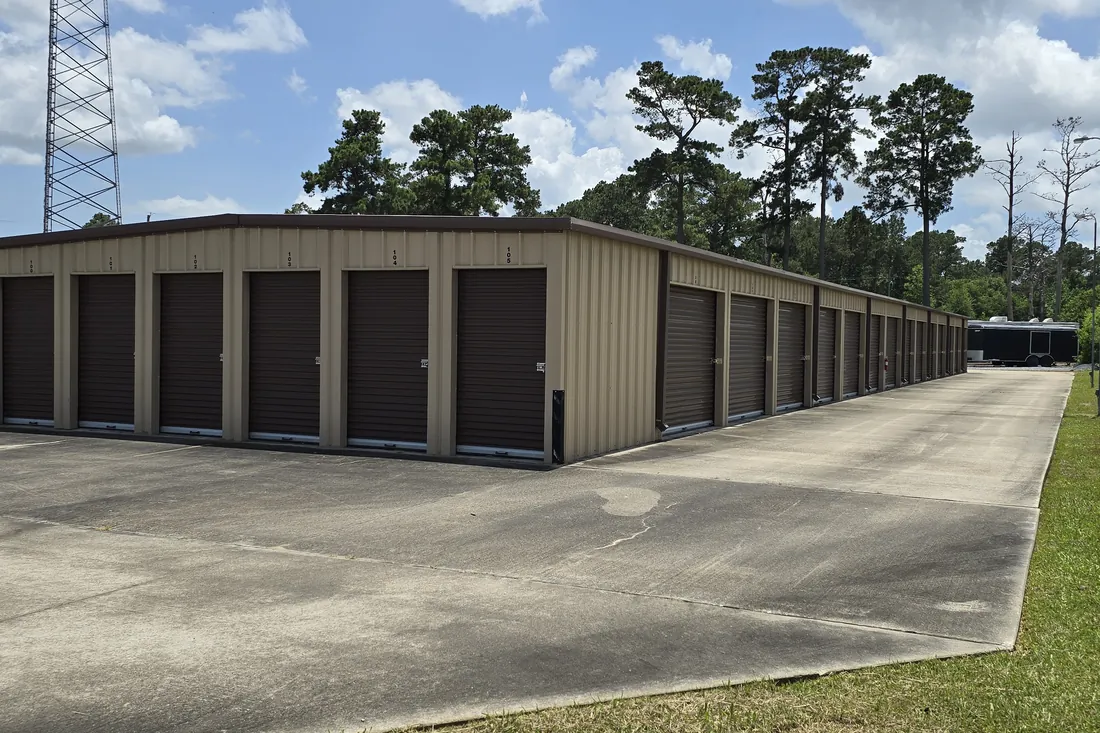 Drive-up storage units under a blue Texas sky at AAA Vault Storage in Orange